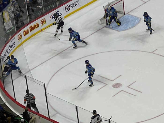 Hermantown and St. Cloud Cathedral players battle for the puck along the end boards during the first period of the Class A state boys hockey championship on Saturday, March 9, 2024, at Xcel Energy Center in St. Paul, Minn. 